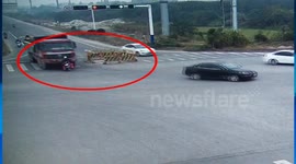 Lucky motorcyclist just escapes wheels of truck