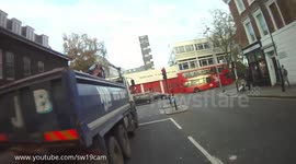 Cyclist sneaks up left side of left turning HGV and disappears. Lucky!