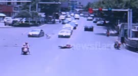 Motorcyclist walks away after crash with car in China