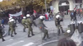 Riot police officer slips over during protest