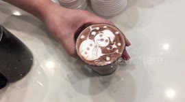 Skilled barista draws intricate snowman on hot chocolate drink