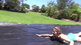 Young Australian girl makes slip 'n slide for cousins