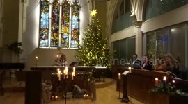 Choir sings at Midnight Eucharist on Christmas Eve at St Philips Church in Kensington