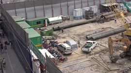 A busy construction site and street traffic in Bangkok.