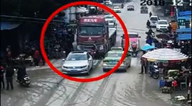 Two pedestrians narrowly escape death after being knocked down by lorry