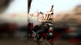Residents flee as three-storey building collapses on busy road in northern India