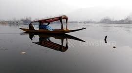 Children play in frozen lake in India