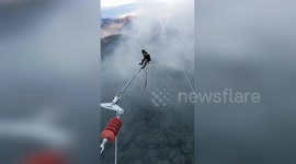 Chinese electricians work on power lines hundreds of feet above the ground