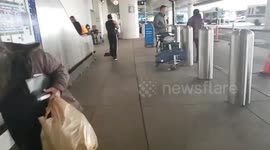 LAX  airport police on a man whose cleaning up LAX