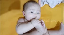 Cute baby loves to suck his toes