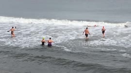 UK swimmers plunge into icy waters in New Year’s Eve celebration