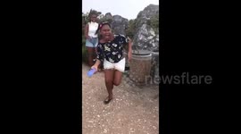 Woman flees in panic as fighting badger leaps onto her