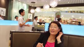 Staff dance in a restaurant in Thailand to entertain customers while they are eating.