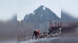 Indian monk in  Minus temperature at 13500 feet breaking ice for bath