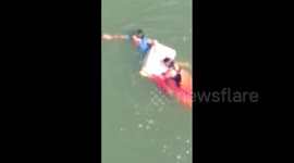Man jumps into river from 70-feet tall bridge to save woman from drowning