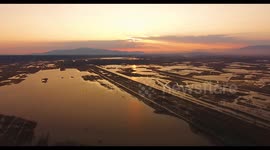 Aerial, beautiful fall landscape on a big pond  on sunset with low water and sun reflections