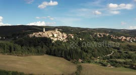 Aerial, little medieval town in Tuscany, San Casciano dei Bagni, Italy on a sunny day