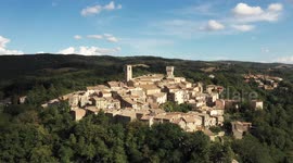 Aerial, little medieval town in Tuscany, San Casciano dei Bagni, Italy on a sunny day