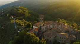 Aerial, an ancient small perched hamlet on sunset in Tuscany, Italy