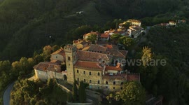 Aerial, an ancient small perched hamlet on sunset in Tuscany, Italy