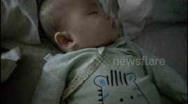 Little baby sucking milk in his dreams