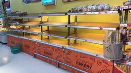 Stranded tourists stockpile food as supermarket shelves are emptied on storm-hit Thai island
