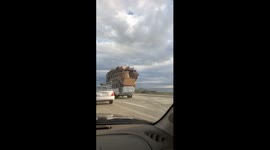 Pick up truck stacked high with couches Tetris style