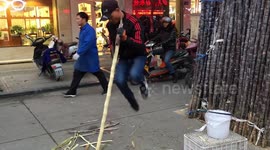 Vendor shows off his kung fu moves while peeling sugarcane