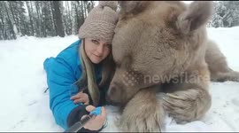 Laying in snow with baby bear