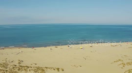 Aerial, large sand beach in the morning in Viareggio, Italy