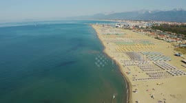 Aerial, large sand beach in the morning in Viareggio, Italy