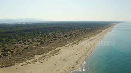 Aerial, large sand beach in the morning in Viareggio, Italy