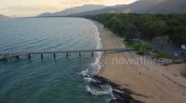 Aerial, beautiful seascape and a  pier and beach with tropical vegetation in Palm Cove, Queensland, Australia