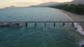 Aerial, beautiful seascape and a  pier and beach with tropical vegetation in Palm Cove, Queensland, Australia