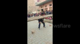 Iron-jawed Indian man throws 60kg log over his head using only his teeth