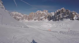 A skier skiing on the track in mountains, action camera footage