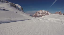 A skier skiing on the track in mountains, action camera footage