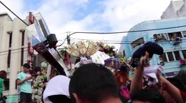 Catholics devotees touch Jesus Christ effigy at festival