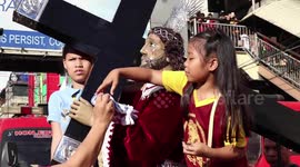 Catholic children tend to Jesus at Black Nazarene procession