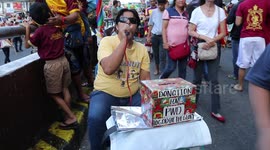 Blind singer entertains devotees at Catholic procession