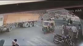Biker has a miraculous escape after being run over by truck in India