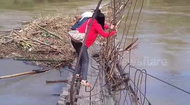 Dedicated teachers cross damaged bridge to reach school in Philippines