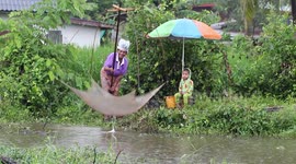 Mother and child catch fishs when it rains.