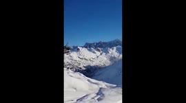 Dramatic moment rescue helicopter sticks nose into snow-covered mountain to reach injured climber