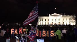 Protesters shout “No wall! No shutdown!” in front of the White House during Trump’s Oval Office address.