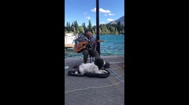 Dog and man singing/ busking