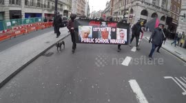 Hooded anti-austerity protestors take over central London street