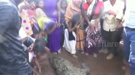 Longer version; Villagers hold funeral for ancient wild crocodile thought to be 100 years old
