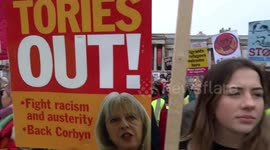 Yellow Vests UK protesters chant What do we want - Tories Out at Britain is Broken anti-austerity march in Trafalgar Square - London