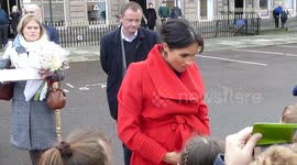 Meghan Markle cradles bump as she greets public on first engagement with Prince Harry of 2019
